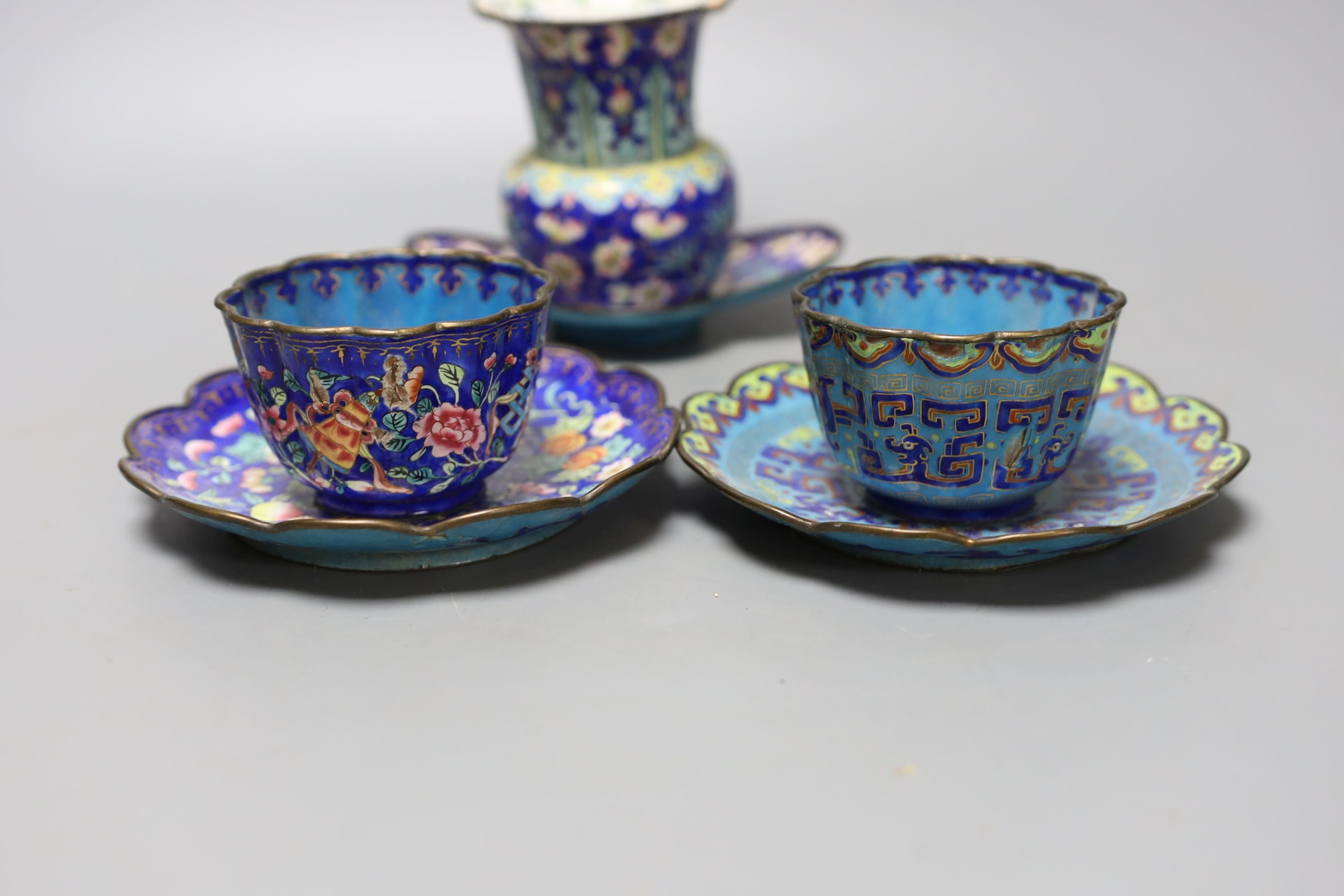 A group of 19th century Canton enamelled wares, including a vase and stand, two tea bowls and saucers and two dishes